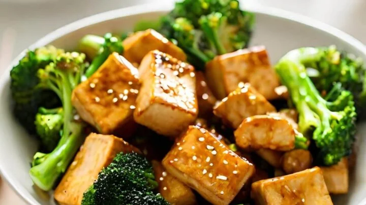 Cooked tofu meal https://17ddblog.com/wp-content/uploads/2023/01/tofubroccolistirfrynewhero1-720x405.jpg